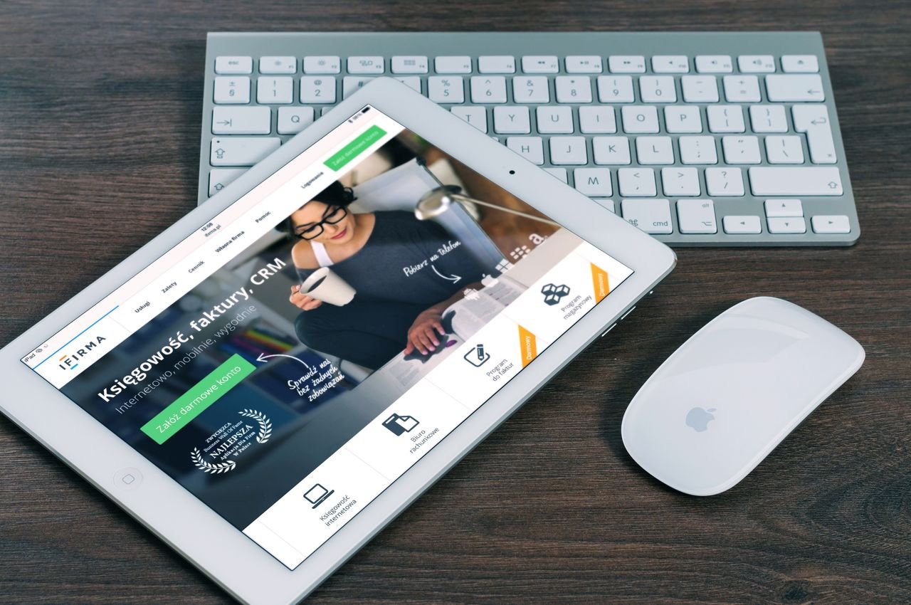 testimonial-img-01 A tablet with a financial website open, alongside a white keyboard and mouse. Ideal for tech-theme stock images.